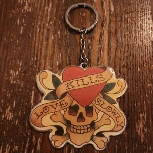 Vintage Ed Hardy key chain with authentic "Love Kills Slowly" writing and design
